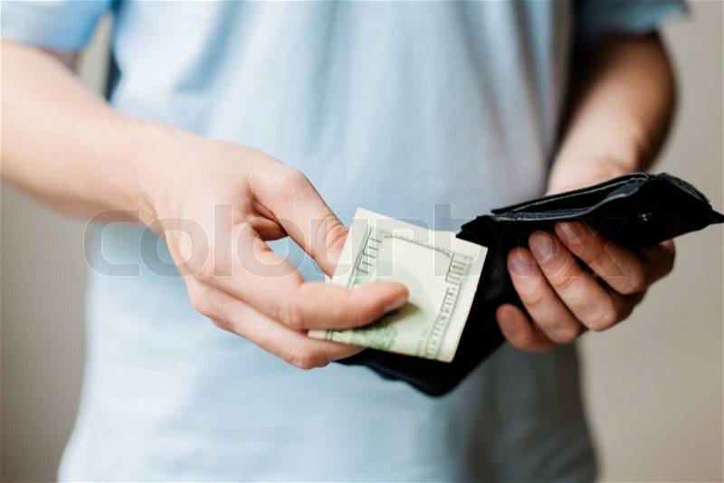 Man gets money from the wallet, stock photo