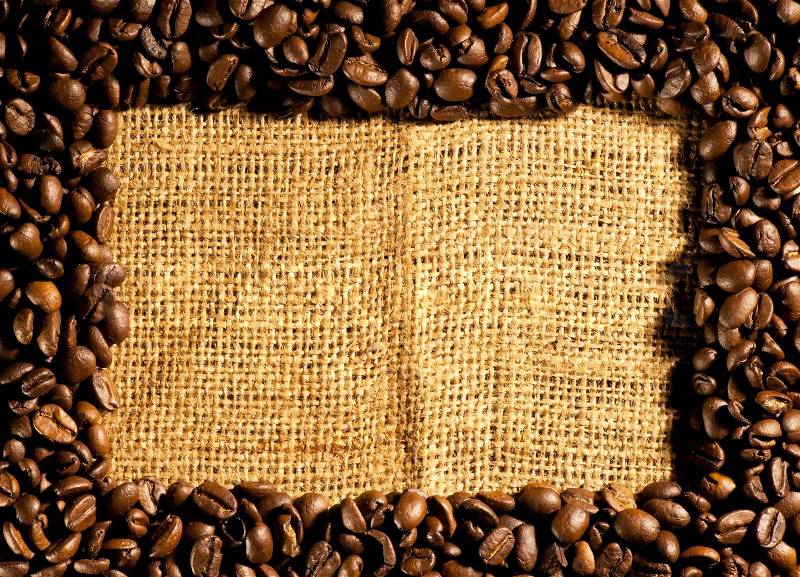 Frame of coffee beans on sacking, stock photo