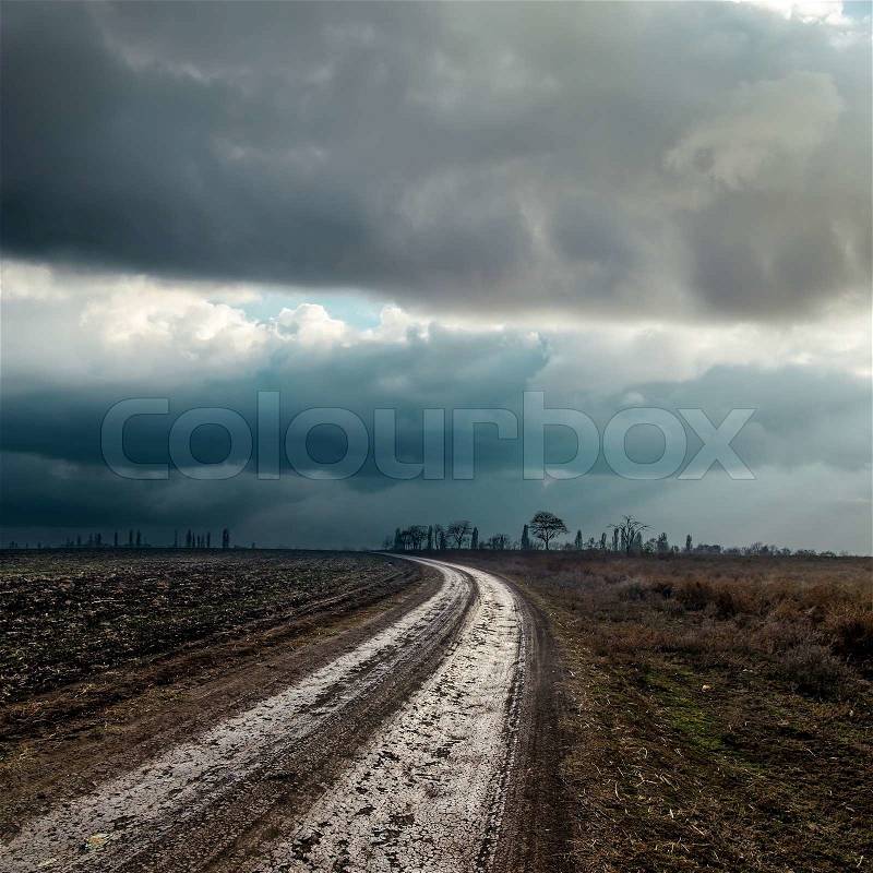 Dirty road to cloudy horizon, stock photo