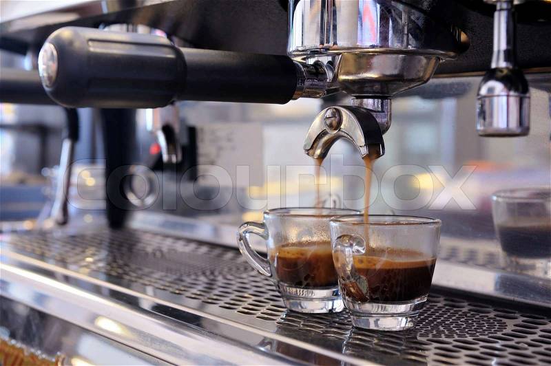 Prepares espresso in his coffee shop close-up, stock photo
