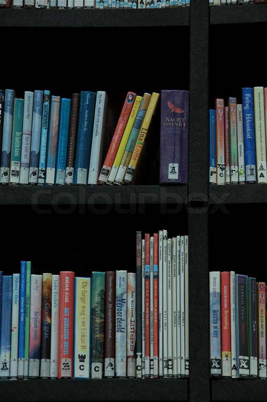 All kind of books in different colours, some disappeared, standing on a bookcase to hire, stock photo