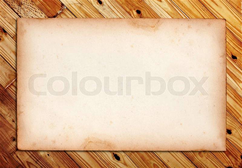 Old note paper on wood background, stock photo
