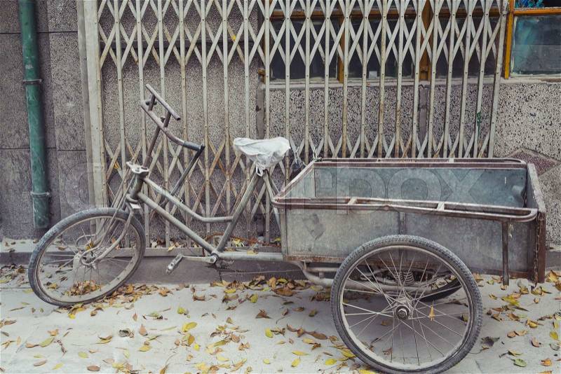 Weathered Bike Parked on sidewalk in Beijing, China, stock photo