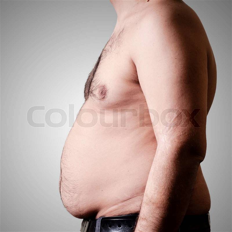 Belly fat man on gray background, stock photo