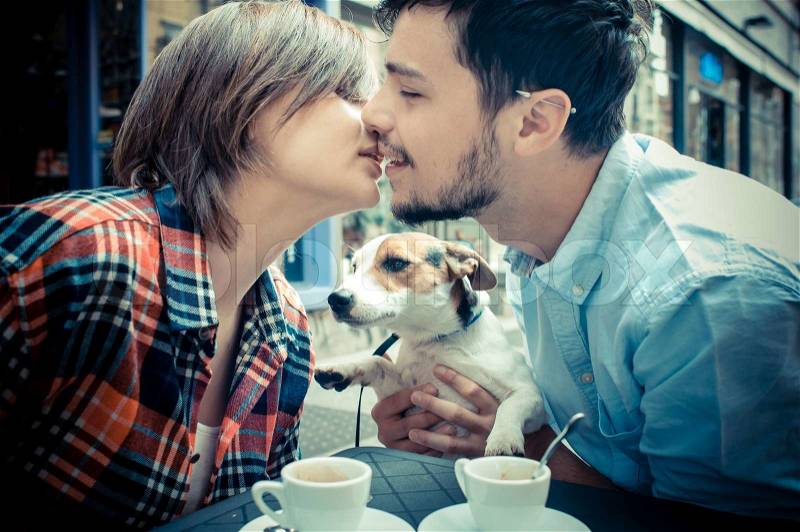 Couple at the bar with jack russell in the city, stock photo