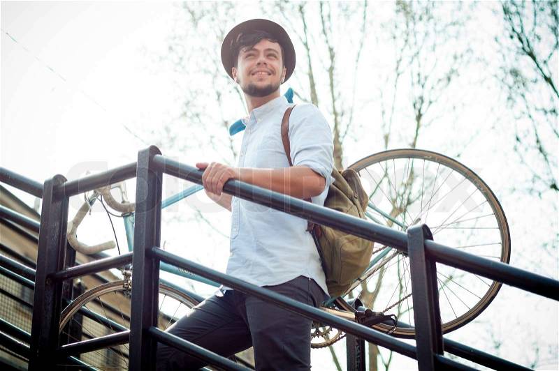 Hipster young man on bike in the city, stock photo