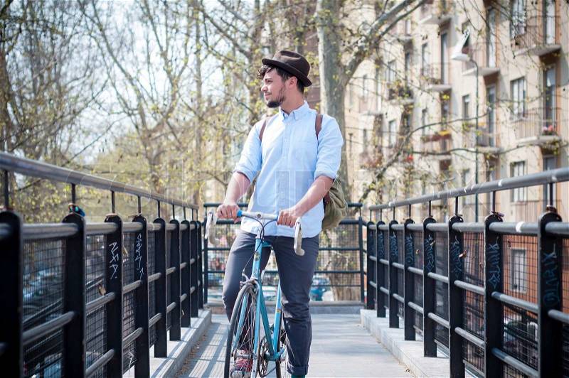 Hipster young man on bike in the city, stock photo