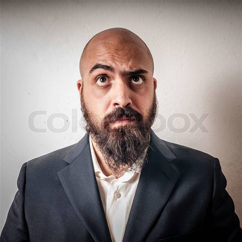 Man with a suit and beard and strange expressions on white background, stock photo