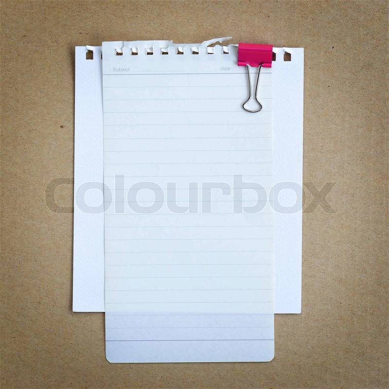 Paper note with pink clip board on brown paper, stock photo