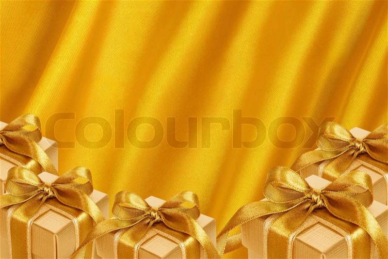 Gold Gift Box on gold satin background, stock photo