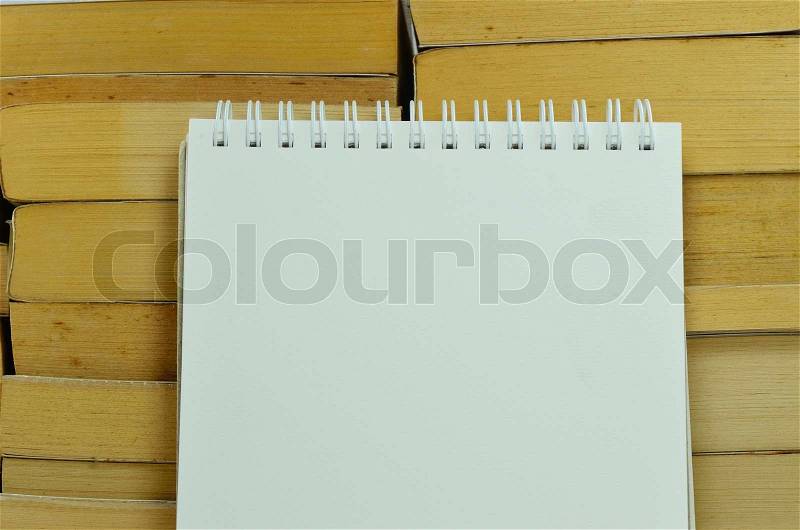 Notebook with ring binder and stack of books, stock photo