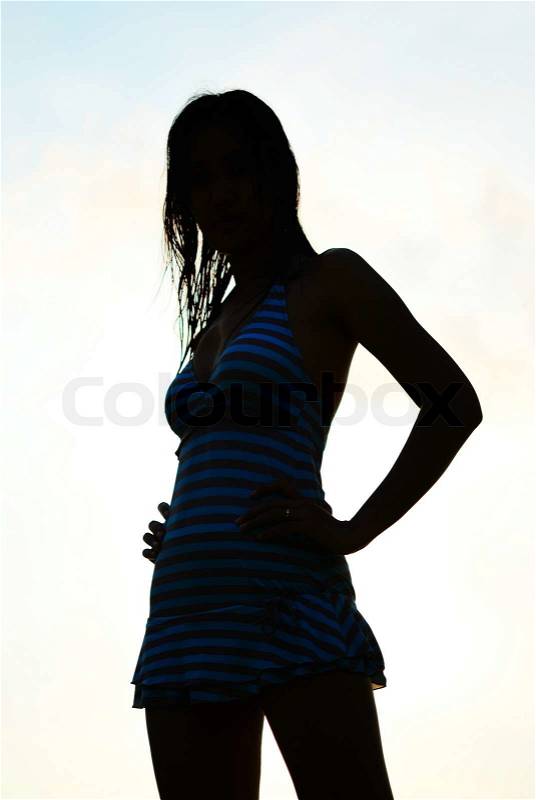 Silhouette of Asian woman in swimming suite, stock photo