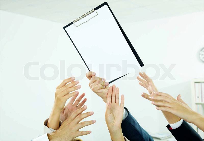 Reaching out for paper, stock photo