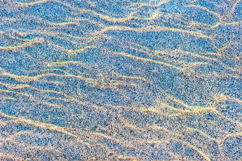 Sun reflections on a marble slab in pool water from above, stock photo