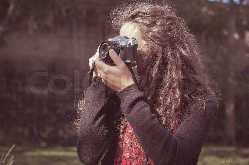 Hipster vintage woman with old camera in the park, stock photo