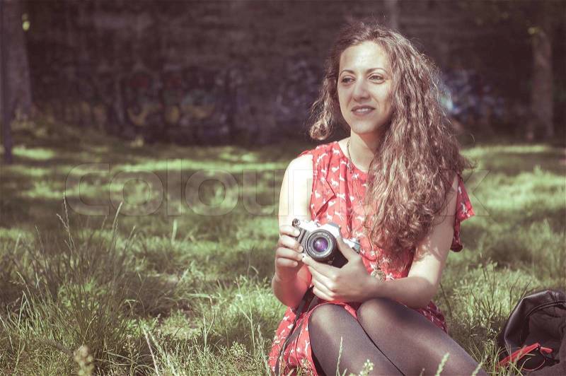 Hipster vintage woman with old camera in the park, stock photo