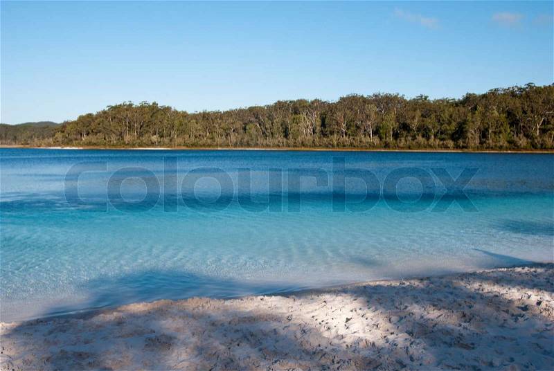 The clear water of this amazing lake viewed from the beach, stock photo