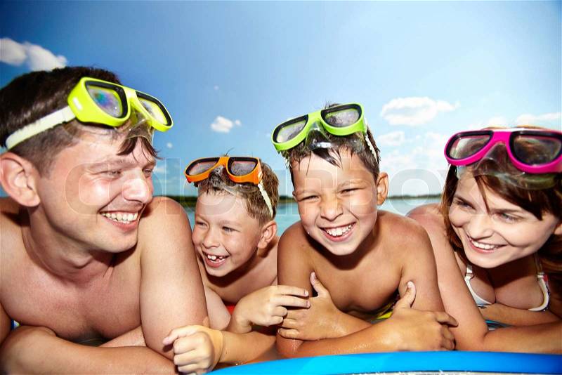Photo of happy family looking at camera during summer recreation, stock photo