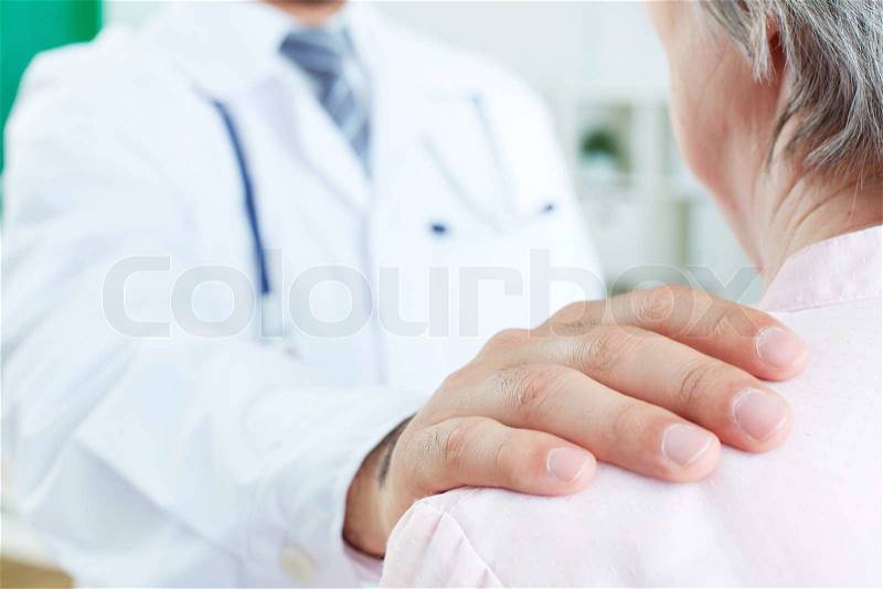 Image of doctor hand on patient shoulder, stock photo