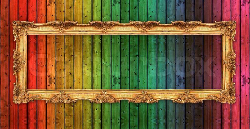 Long old golden frame over colorful wooden wall. beautiful vintage background, stock photo