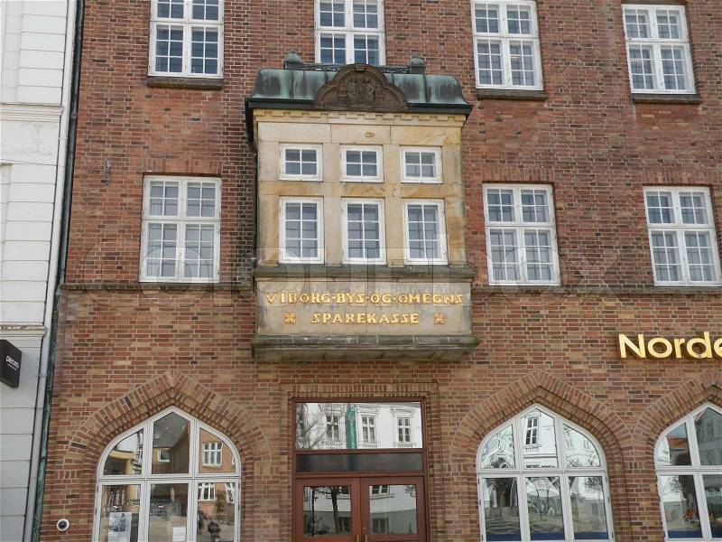 Old red brick bank Building still used as bank in Viborg city, Jutland, Denmark, stock photo