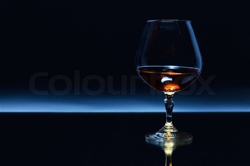 Snifter with brandy on a dark background, stock photo