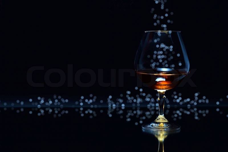 Snifter with brandy on a dark background, stock photo