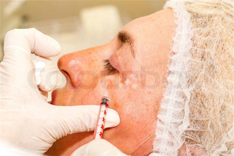 Cosmetic treatment with botox injection in a clinic, stock photo