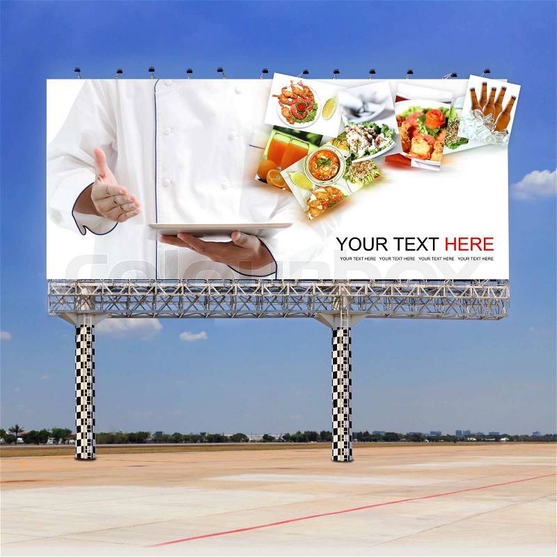 Chef using digital tablet on outdoor billboard, stock photo