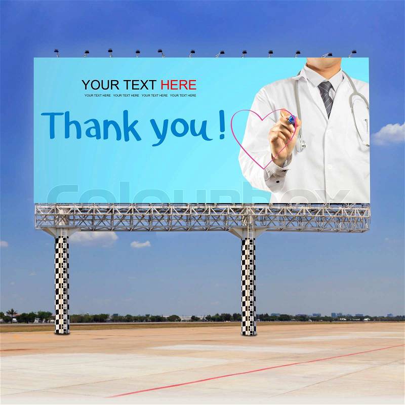 Doctor writing a pink heart with Thank you text on outdoor billboard, stock photo