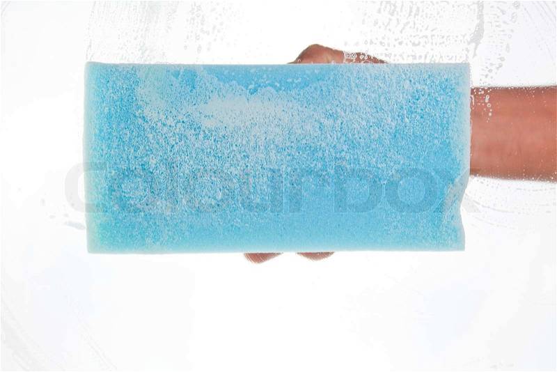 Window cleaner using a blue sponge, stock photo