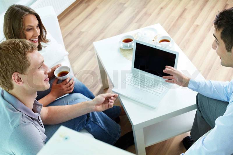 Manager presenting insurance program terms to young couple, stock photo