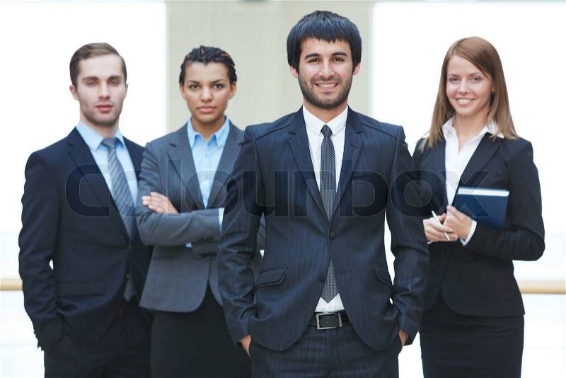 Group of confident businesspeople with male leader in front, stock photo