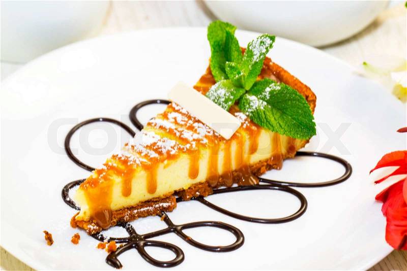 A piece of cheese cake on a table in a restaurant, stock photo