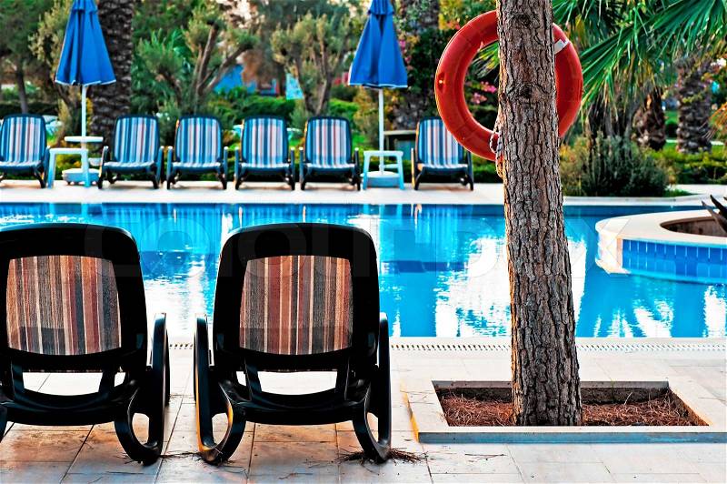 Chaise lounge by the pool to relax in the villa, stock photo