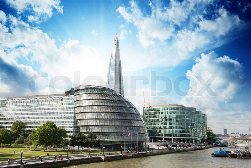 New London city hall with Thames river and cloudy sky, panoramic view from Tower Bridge - UK, stock photo