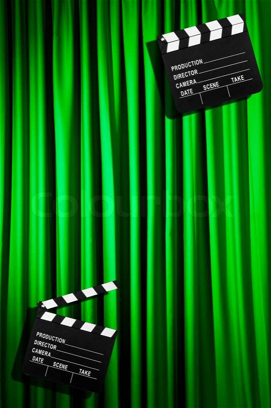 Movie clapper board against curtain, stock photo