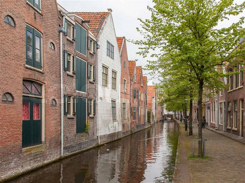 Traditional dutch buildings on canal in Alkmaar, the Netherlands, stock photo