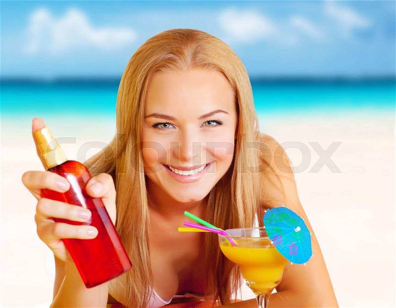 Closeup portrait of happy attractive woman with sunscreen and tasty cocktail having fun on the beach, relaxation on seashore, summer vacation concept, stock photo