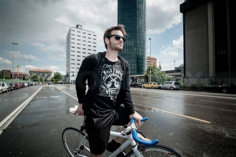 Stylish man on bike in the city, stock photo