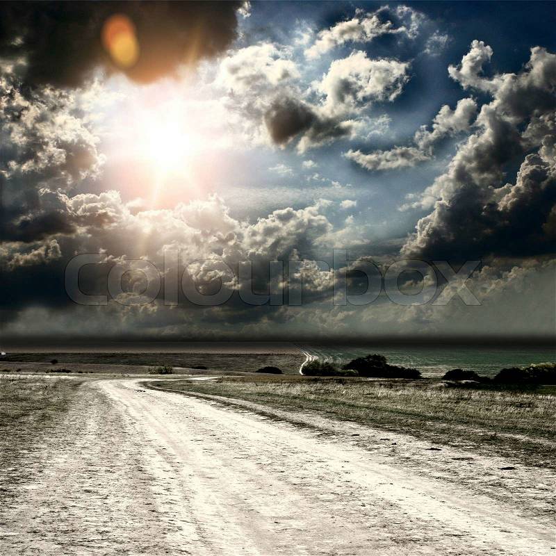 Road and fields on the background of the beautiful sky, stock photo