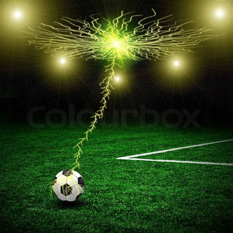Soccer ball on the green field and lightning, stock photo