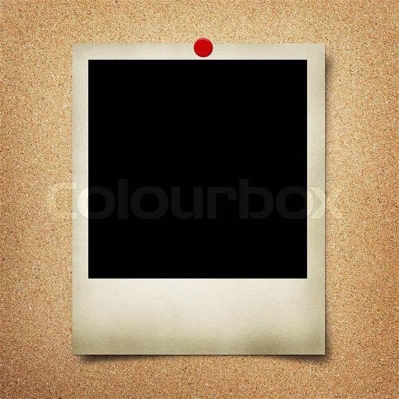 Blank photo pinned to cork board, stock photo