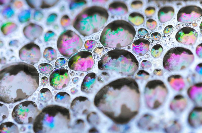 Macro photo of colorful soap bubbles on the water, stock photo