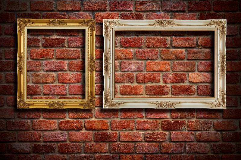Gold frame and White frame hang on old brick wall background, stock photo