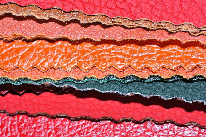 A stack of multicolored artificial leather swatches close-up, stock photo