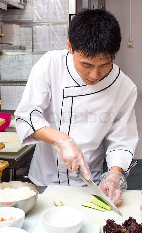 Japanese chef with a plate of sushi, stock photo