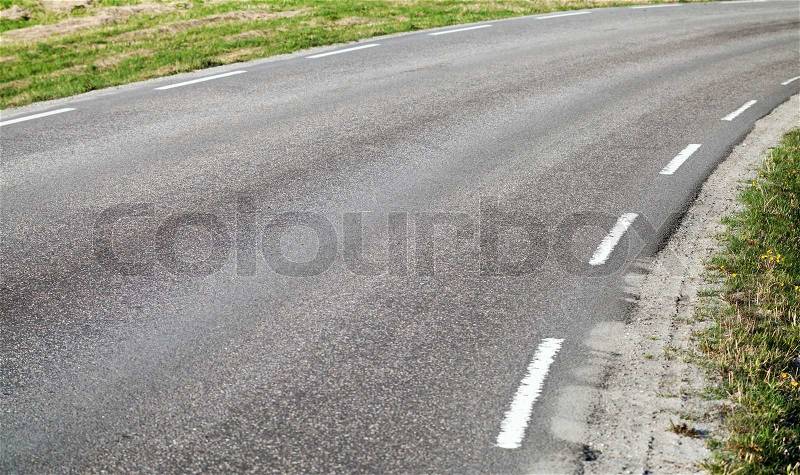 Turning asphalt road with marking lines, stock photo