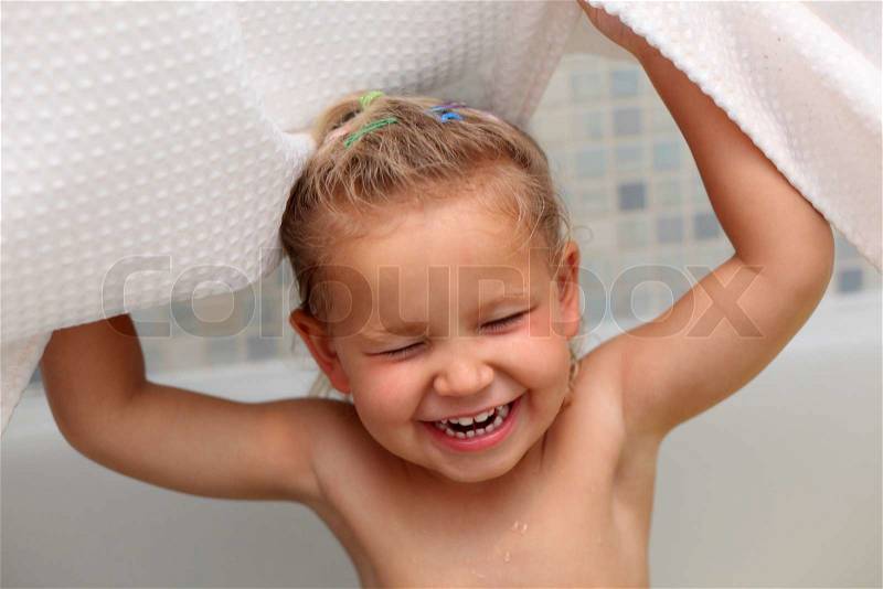 Little girl having fun in the bath tub , stock photo