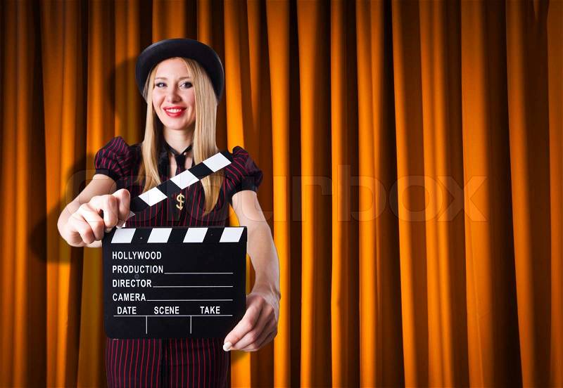 Woman gangster with movie clapper, stock photo